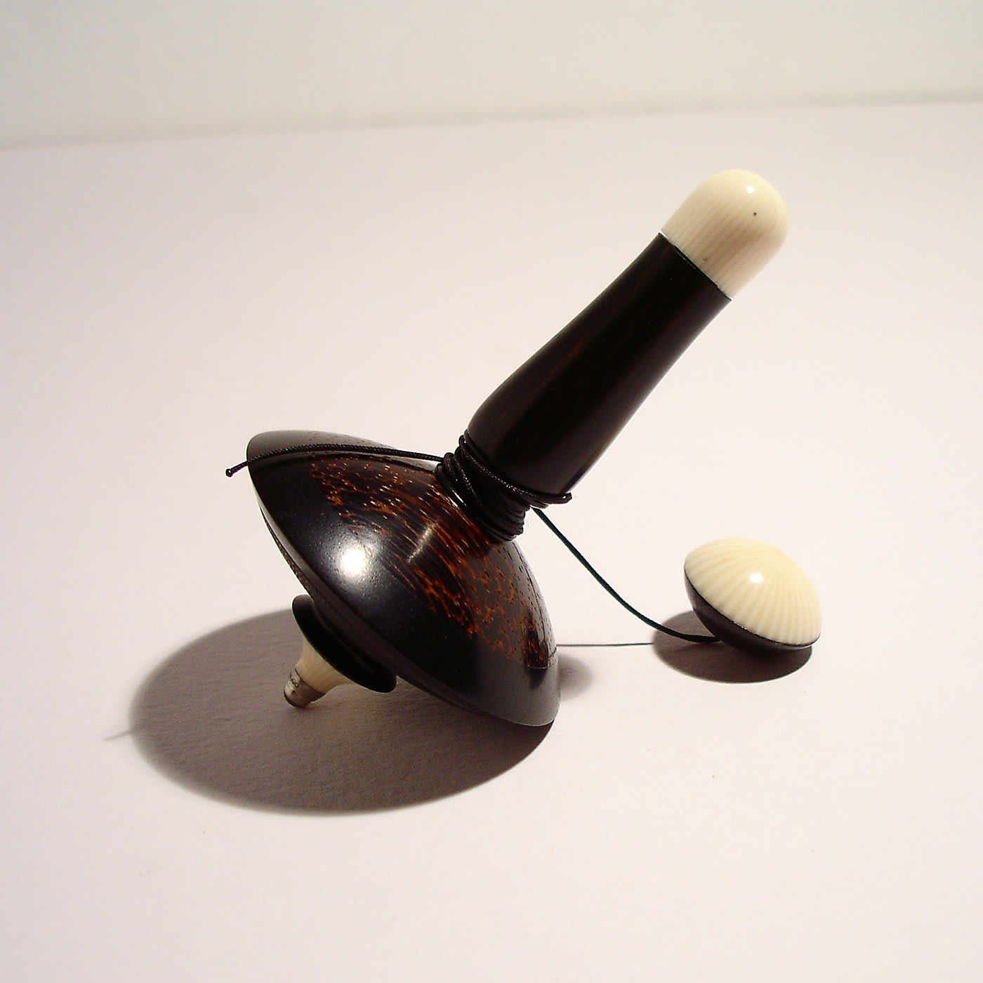 Filo Spinning Top in Ebony, Galalith and Black Palm - Mauro Sarti